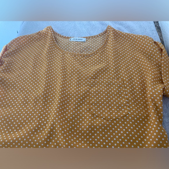 Yellow with white polka dots and button up closure in back. Size medium. - Picture 2 of 5